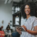 Business woman holding digital tablet smiling